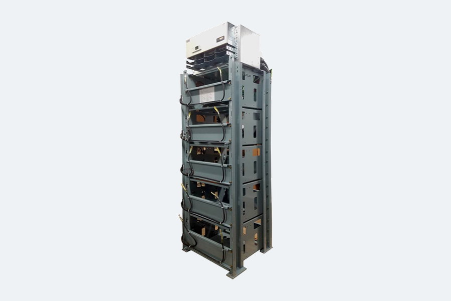 A multi-tier powder-coated steel battery rack loaded with batteries on each level, with inter-tier cabling.